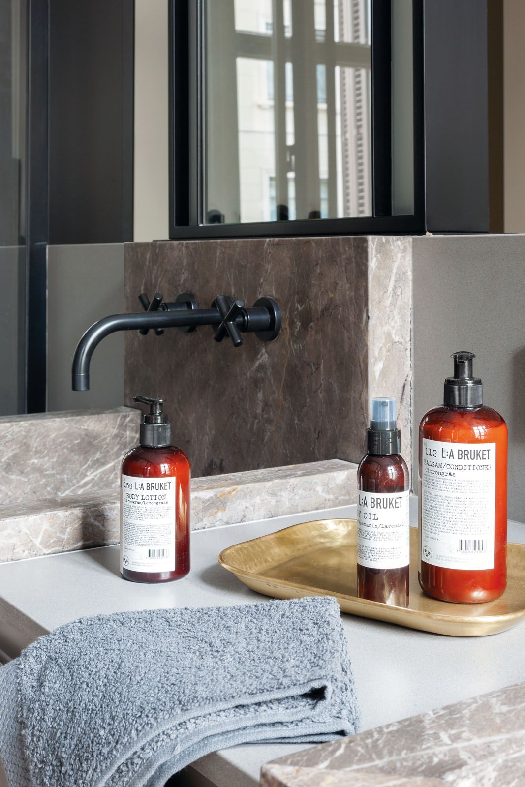 The master bathroom features Italian stone-top sinks and Dornbracht faucets