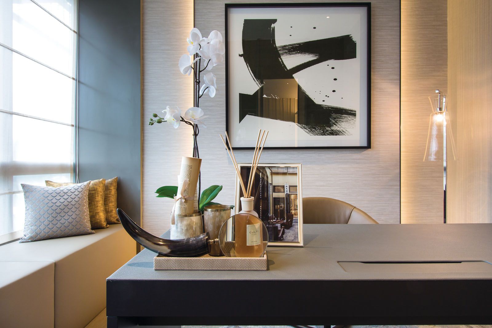 A calligraphy artwork anchors the study area of the master bedroom