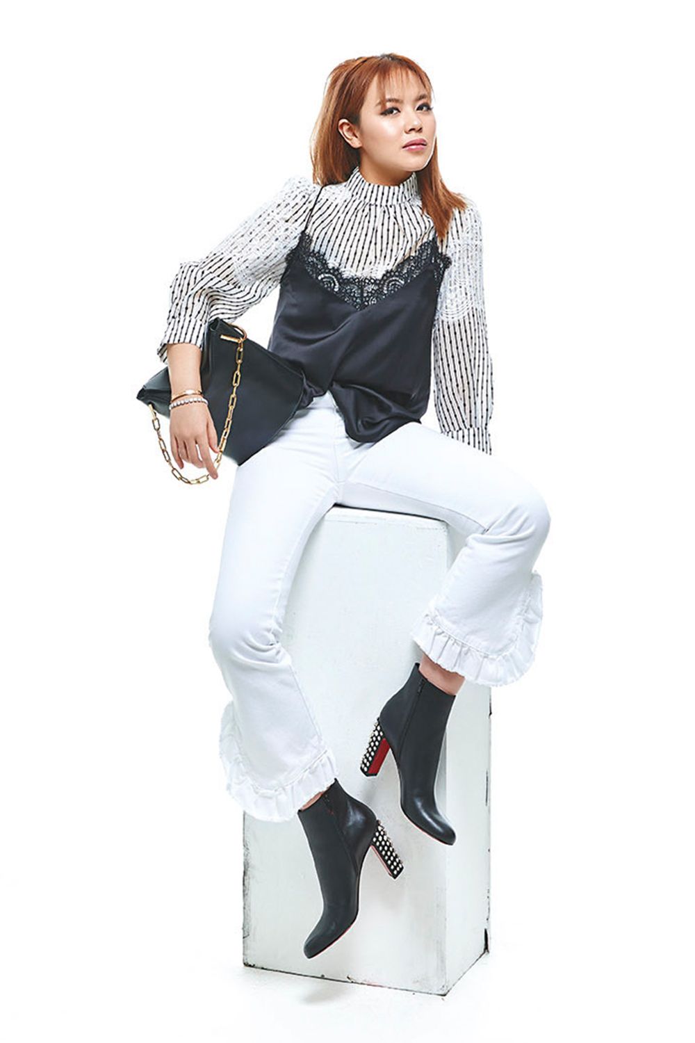 Viscose blouse with lace panel by Aijek and lace camisole by Ai’telier, both at Trixilini; white denim cropped jeans with ruffles by MSGM, at Closet; leather booties with studs by Christian Louboutin; leather bucket bag with chain by Gianni Chiarini, at Lusso Italiano; diamond bracelet by Empire Treasures; bracelet, Chloe’s own