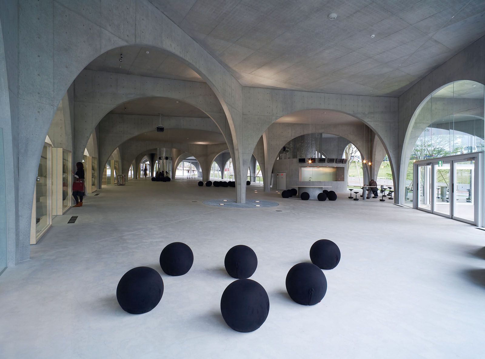 The Tama Art University in Tokyo features voluminous spaces created by stacking arched windows on top on one another