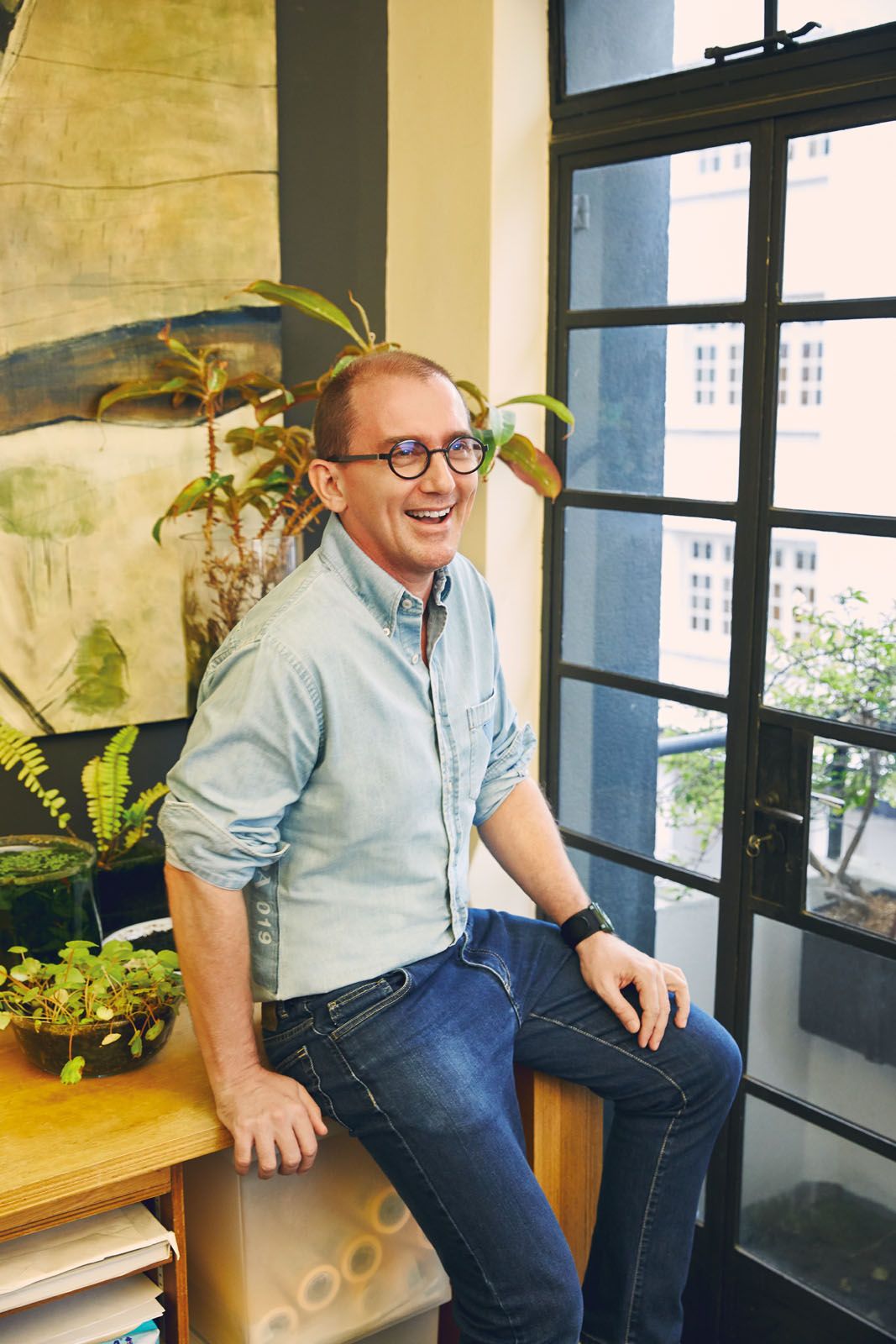 Richard Hassell’s outlook on sustainability was influenced by his forward‑thinking father’s environmental interest. He wears denim shirt by Prada