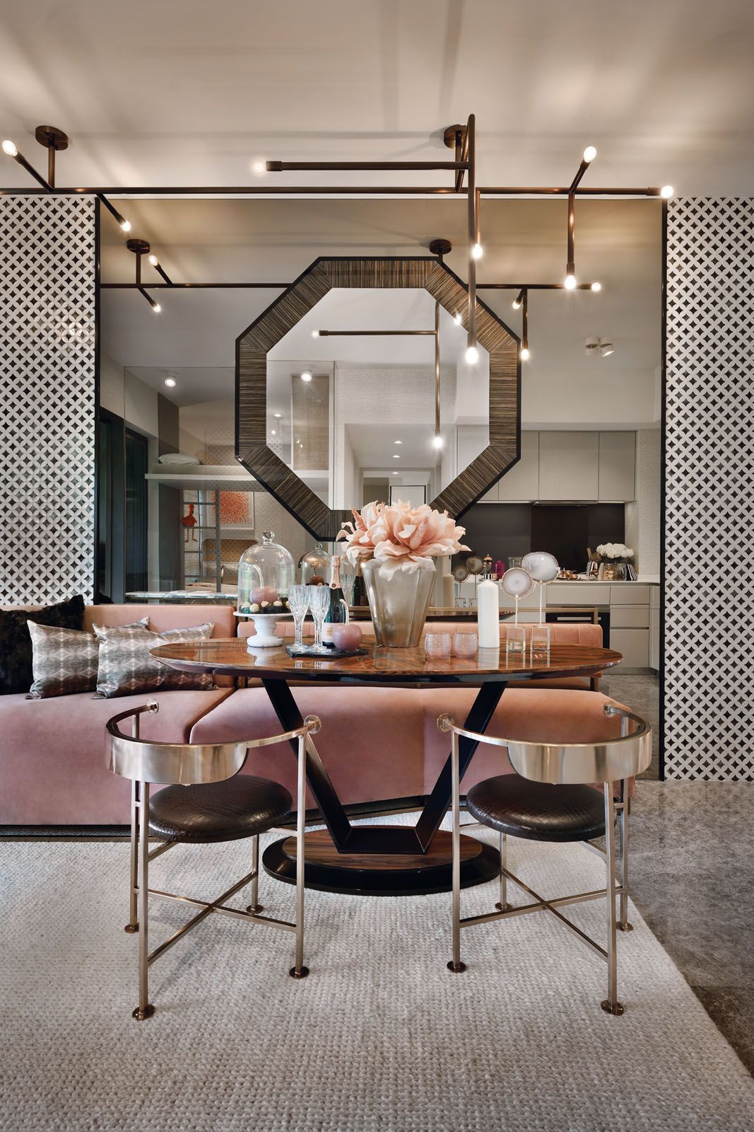 The blush pink sofa adds a feminine touch to the dining area at the Margaret Ville showflat