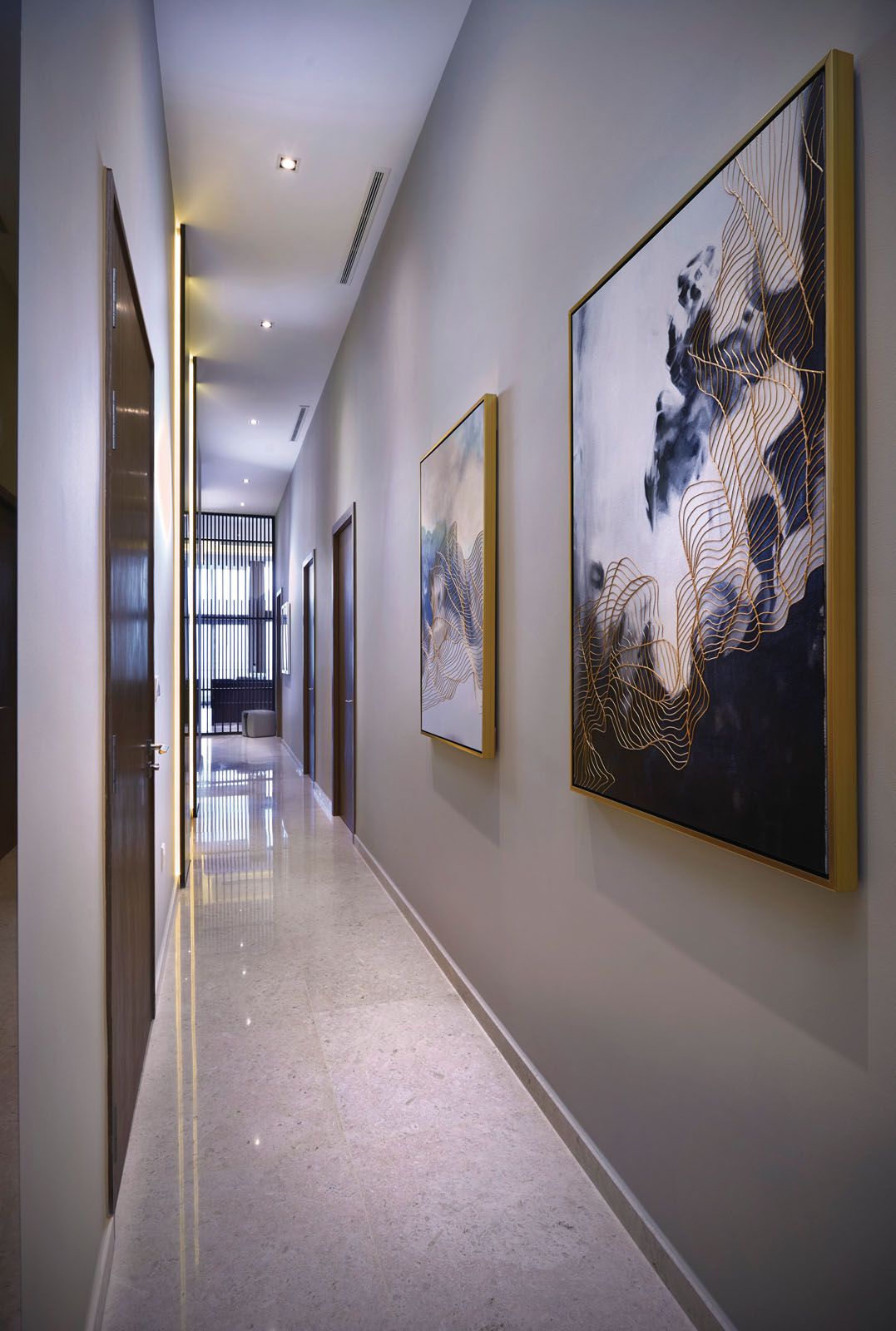 The wave motif on the abstract artworks liven up the long corridor