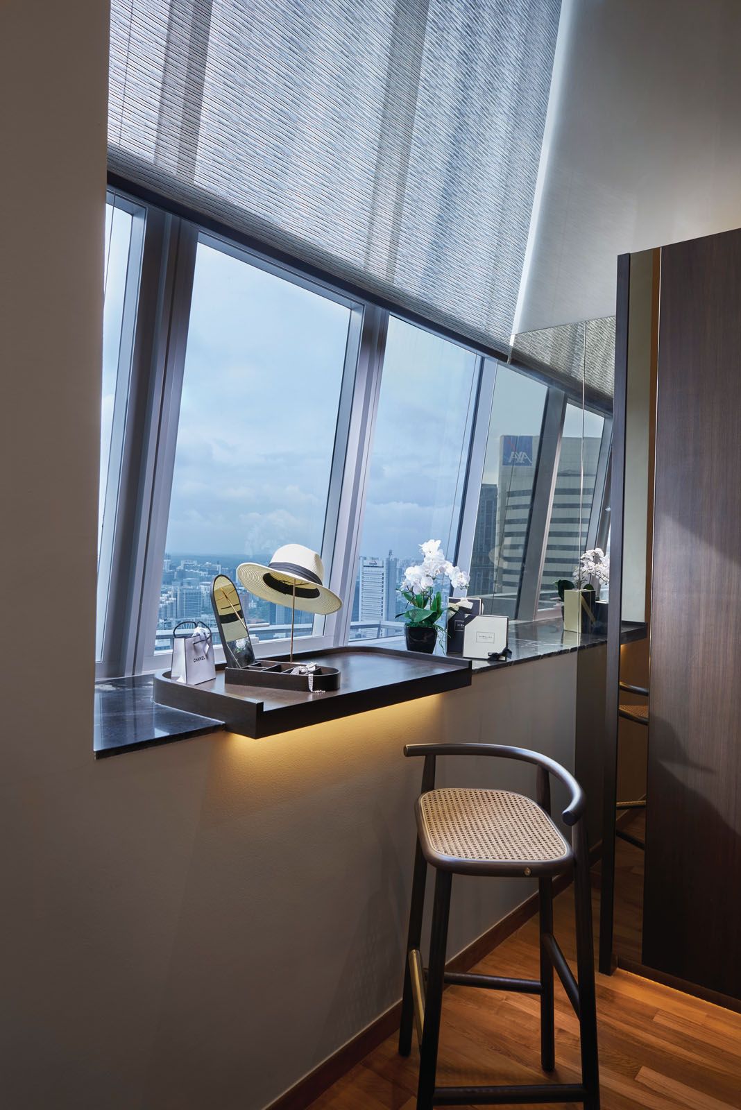 The bay area features a built-in desk and bar stool that faces scenic views of the city