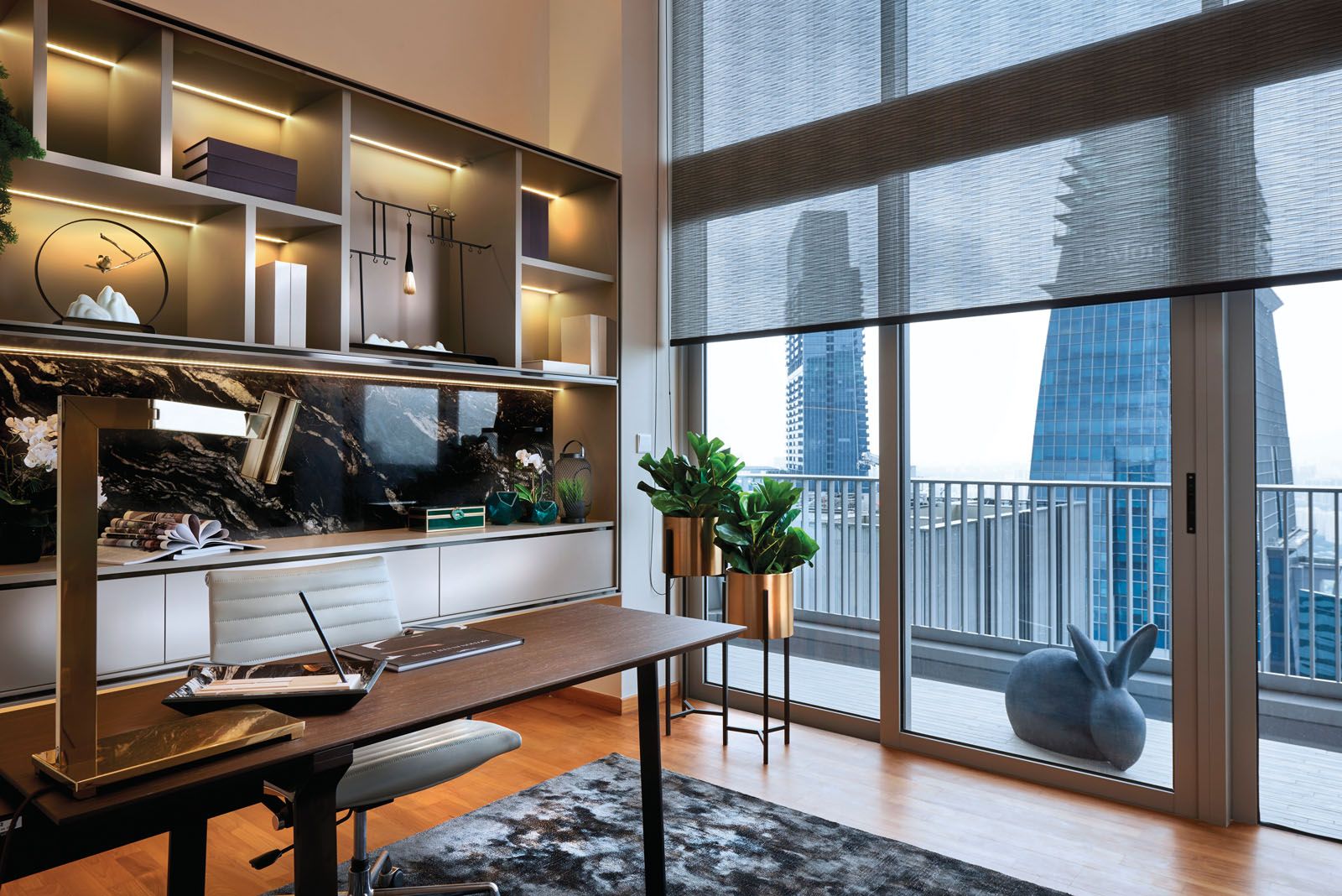 The bookshelves are illuminated with built-in lighting to display the family’s favourite pieces