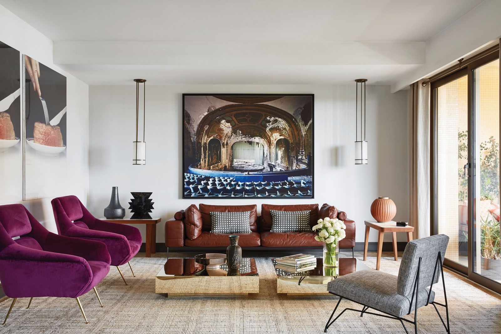 Contemporary pieces such as the Flexform leather sofa and side tables are paired with the Yantara vase by Ettore Sottsass and vintage armchairs in the living room