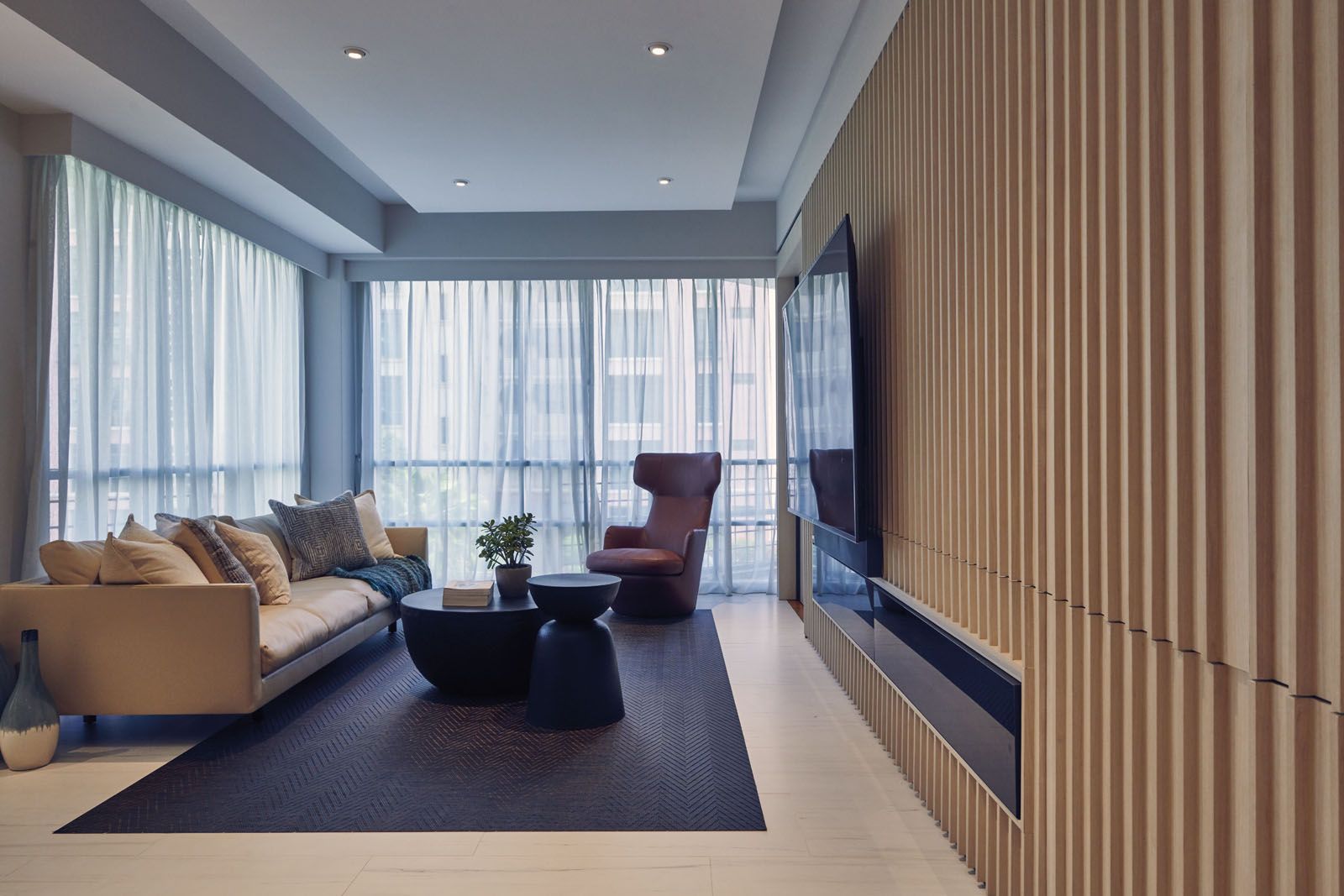 The wooden panelling functions as a sliding door while housing storage and the built-in TV console