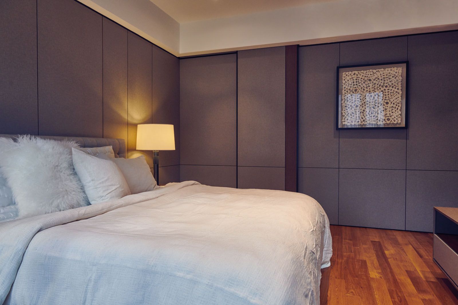The master bedroom sports a darker palette to create an intimate mood