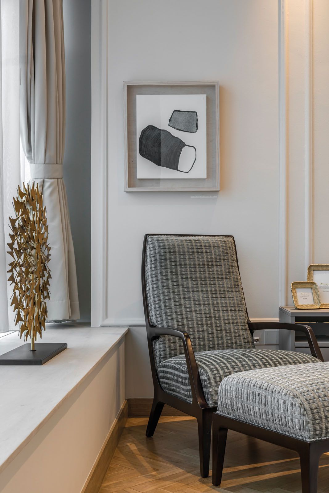 Eye-catching pieces in the master bedroom include the gold sculpture displayed on the bay window