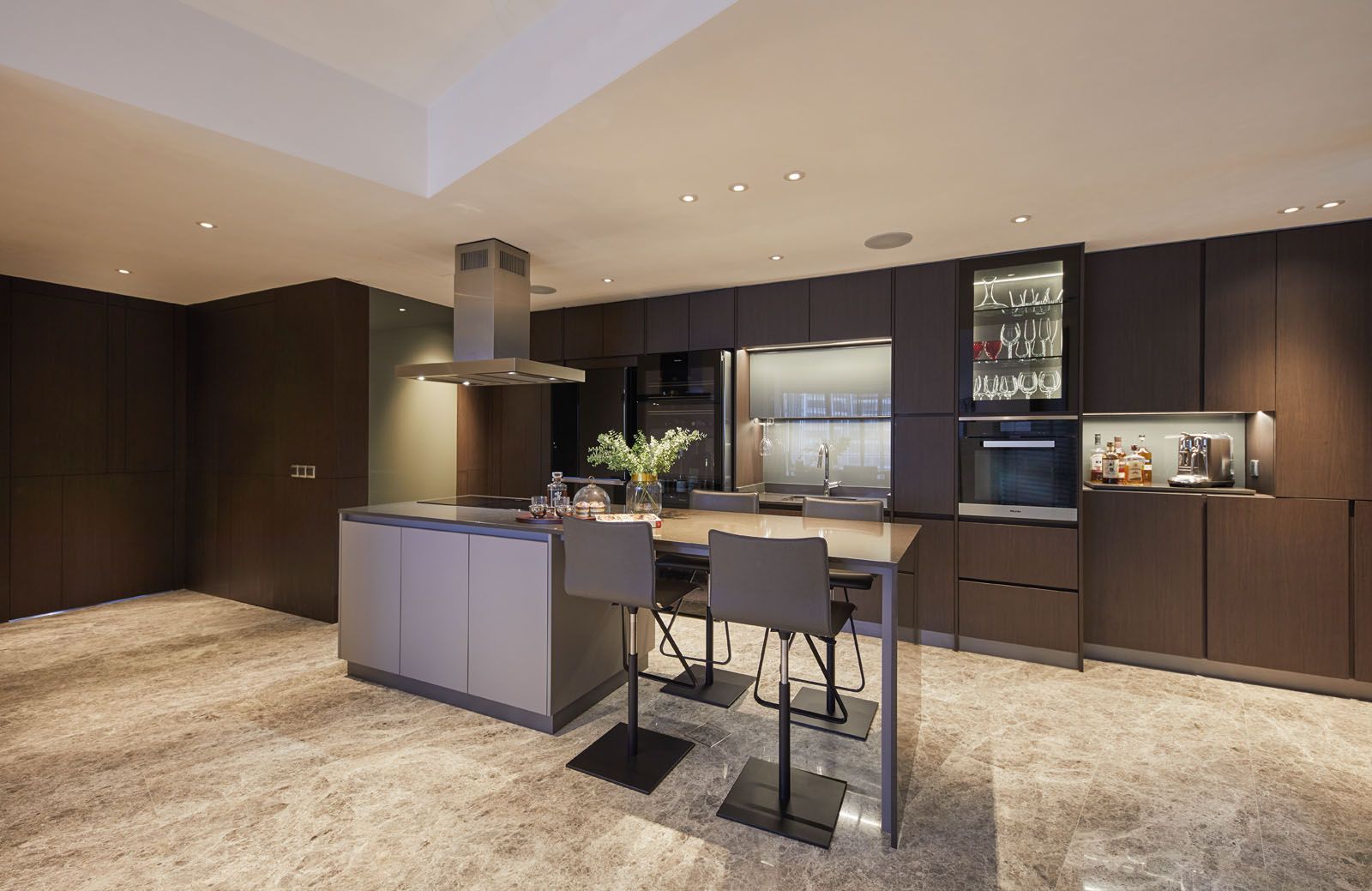 The kitchen cabinetry and the doors that lead to the other rooms feature the same timber panelling to create a seamless look;