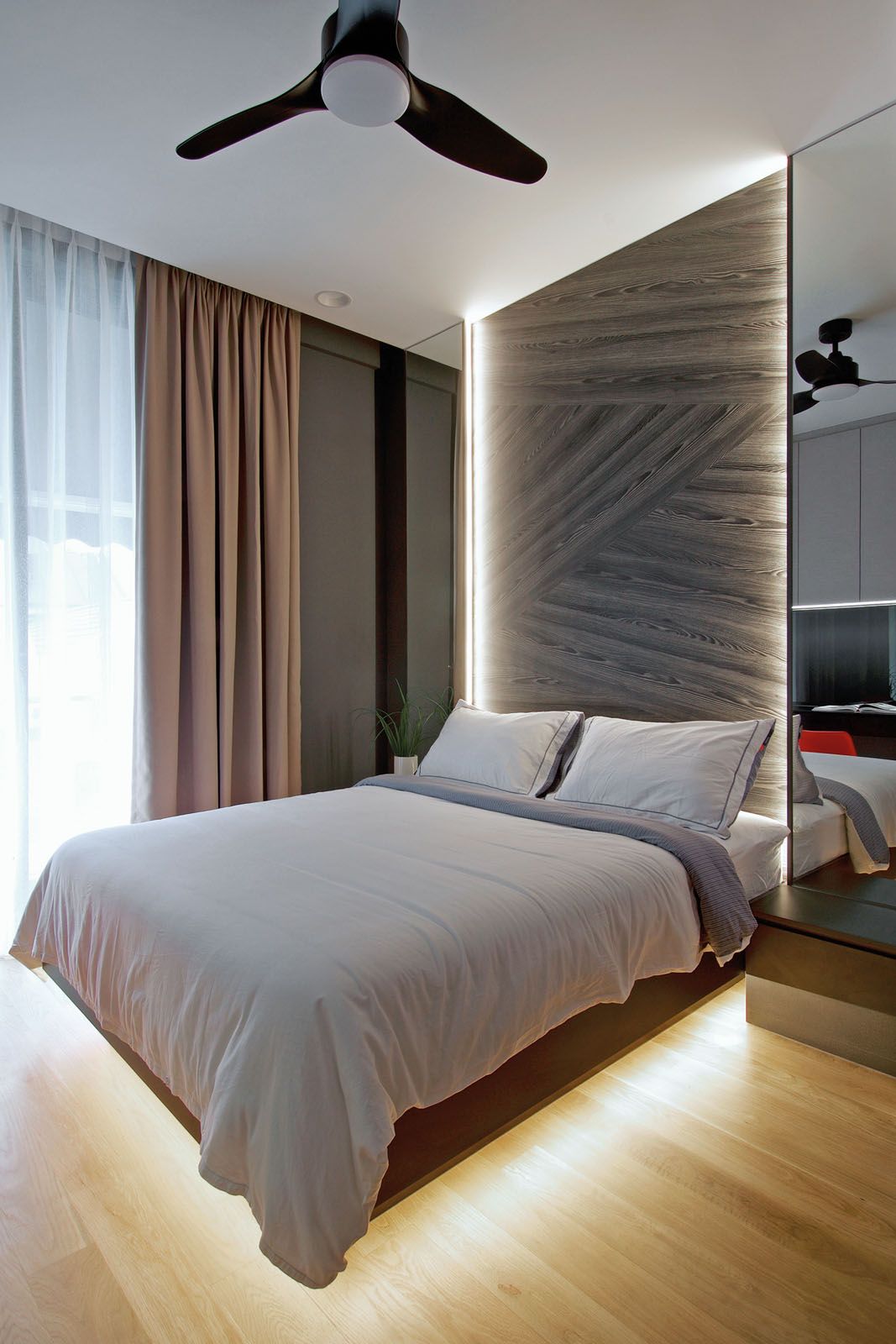The unique woodgrain of the feature wall adds a tactile dimension to another bedroom