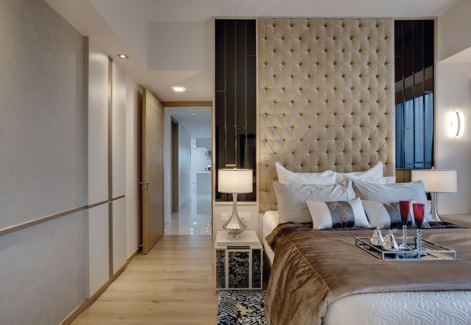 The upholstered headboard in the master bedroom draws the eye upwards to create a sense of height