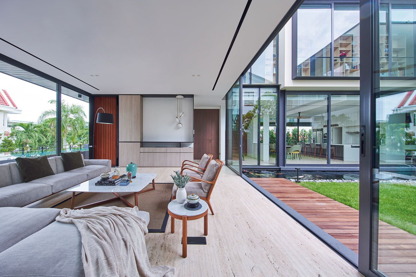 The living room features an array of furniture from Flexform, complemented with a floor lamp from BoConcept and pendant lights from Lee Broom