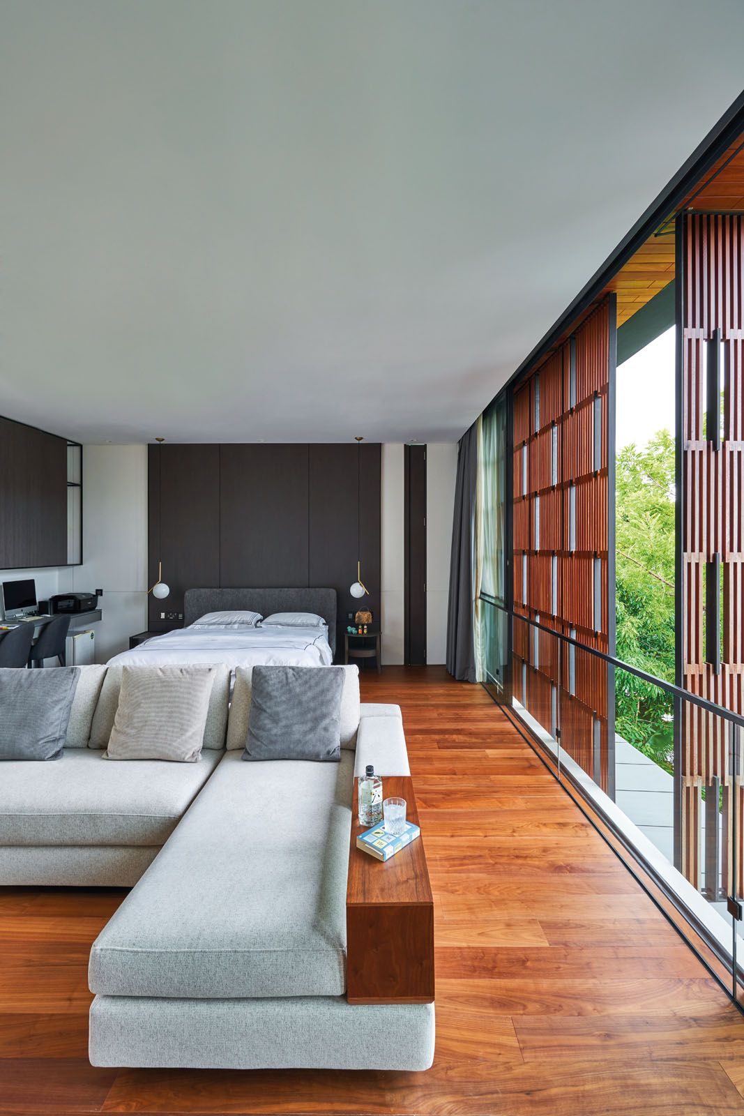 The master bedroom features a bed from Molteni&C, a sofa from King Living and a pair of pendant lights from Flos