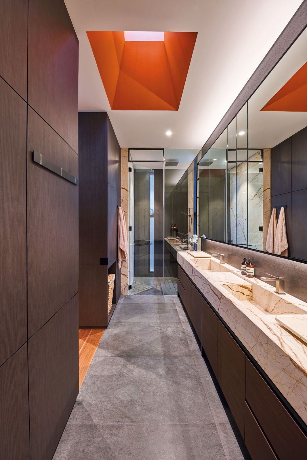 The orange skylight adds a dash of colour to the master bathroom