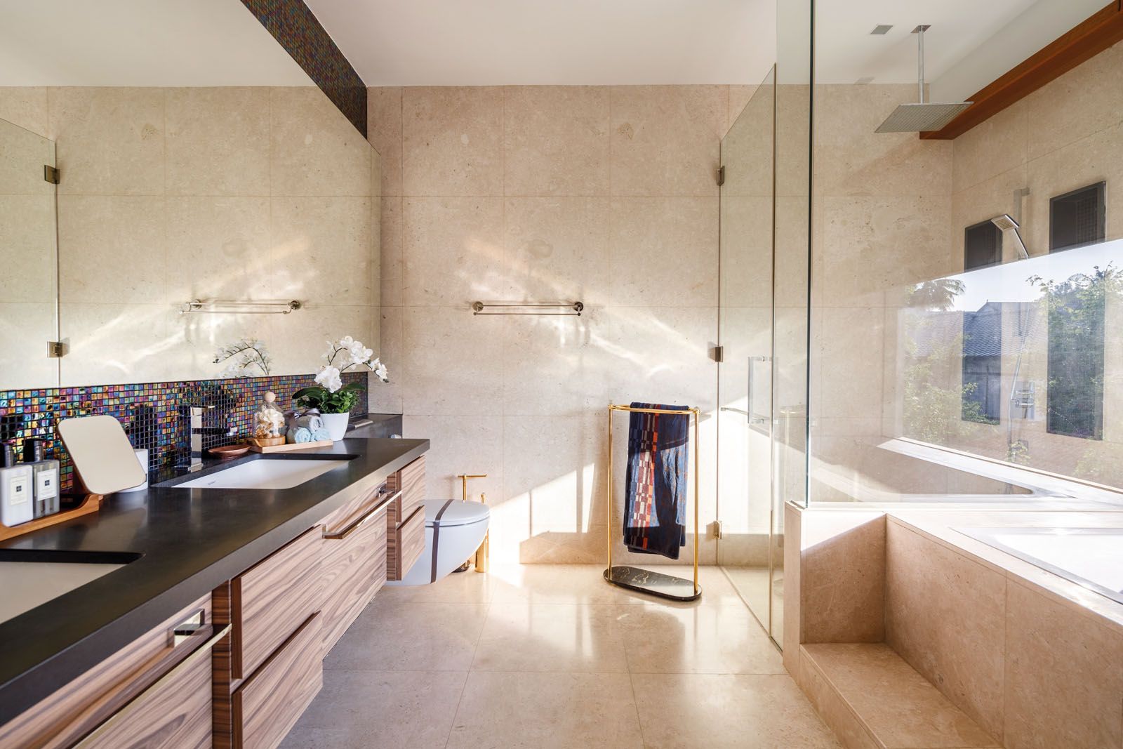 The master bathroom is a tranquil space decked in natural stone