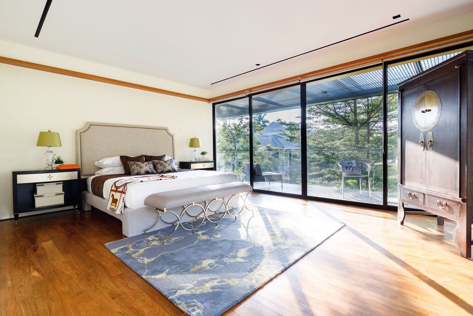 Metallic detailing on the bench and bedside tables bring a touch of glamour to the serene master bedroom