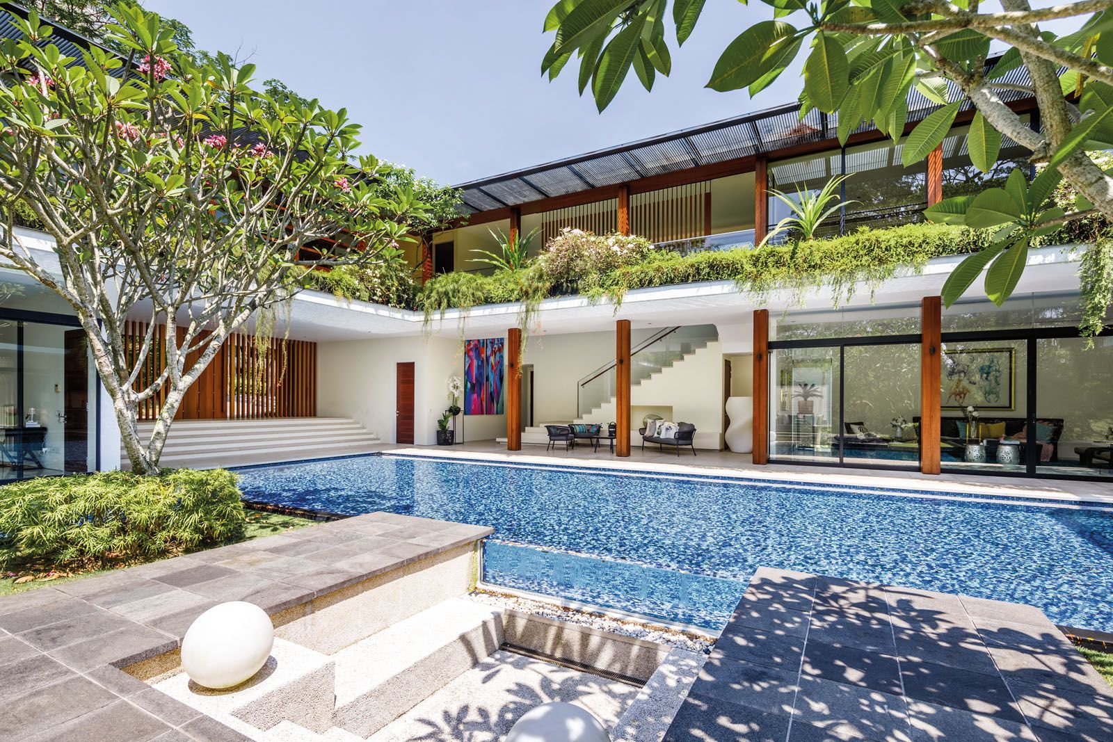 The house is a U-shaped structure that faces the pool and courtyard