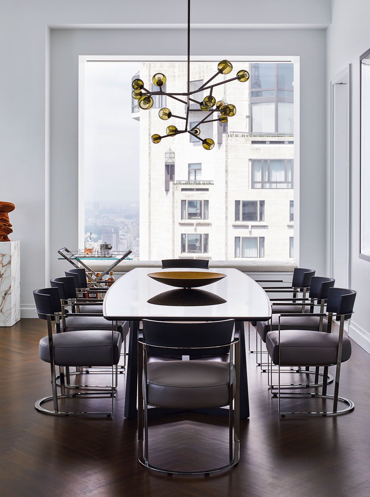 The dining area features a Damien Langlois-Meurinne chandelier and Flexform furniture
