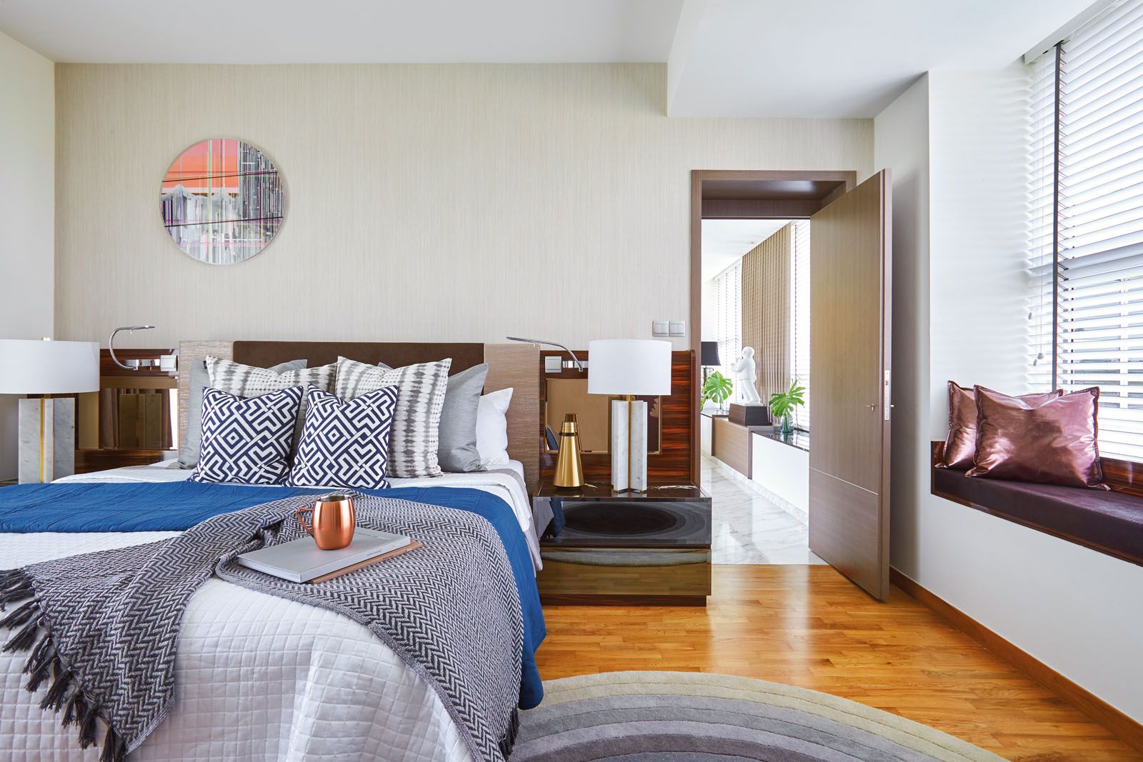 The ikat-like pattern and geometric prints on the cushions add to the relaxed vibe of the master bedroom