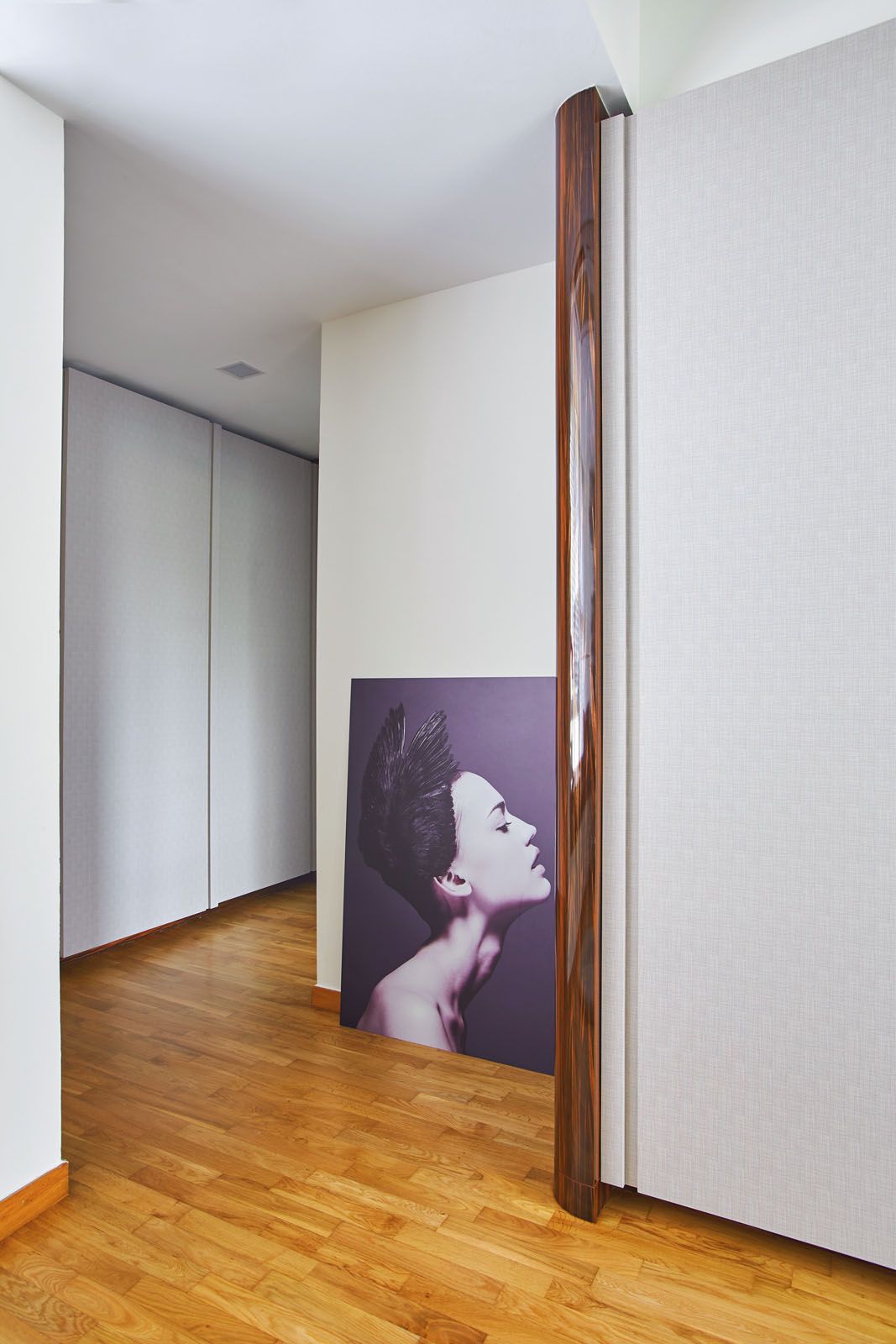 Fabric wallpaper and metal trimmings add texture to the corridor