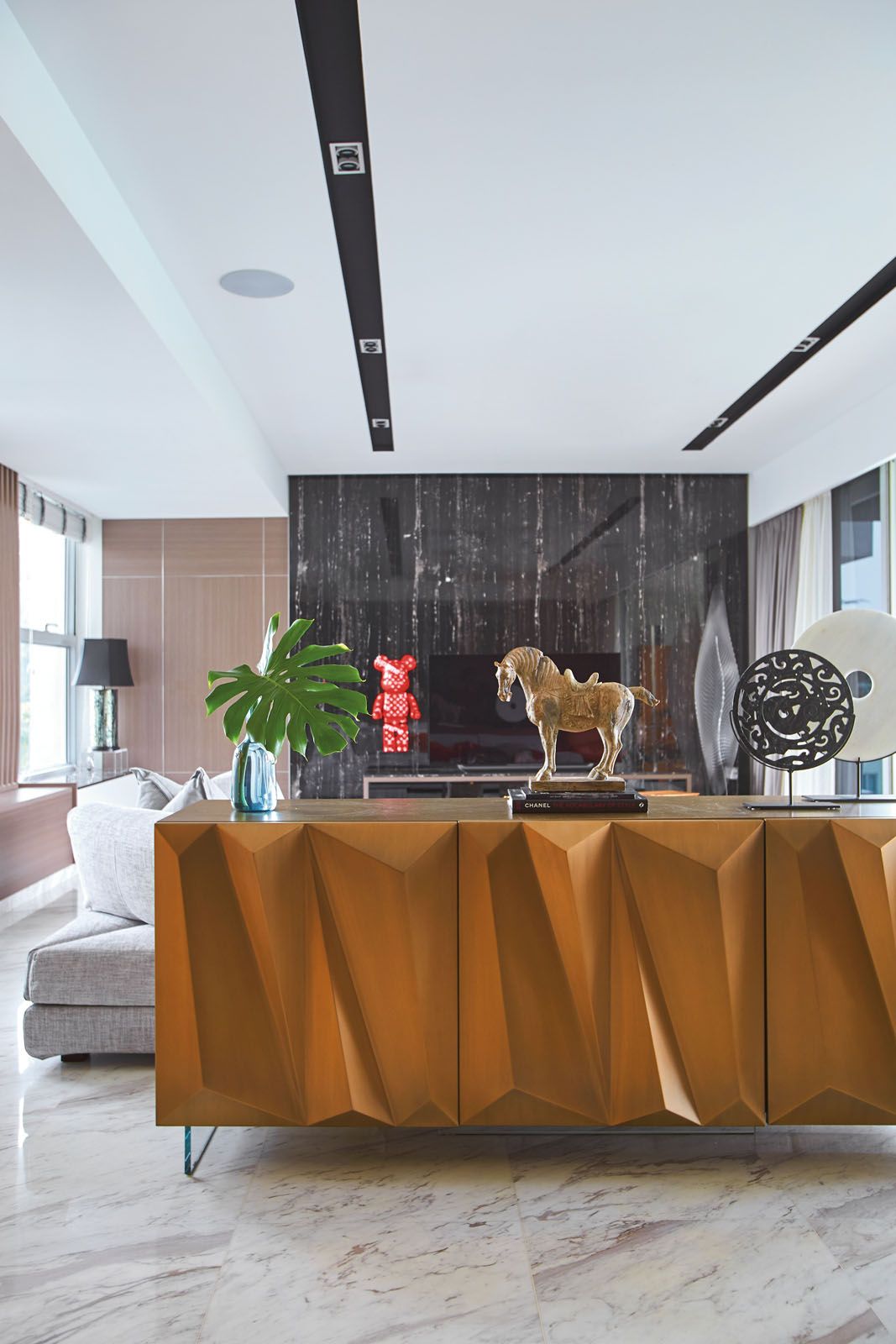 The Reflex sideboard separates the living area from the kitchen, while showcasing an array of decorative objects