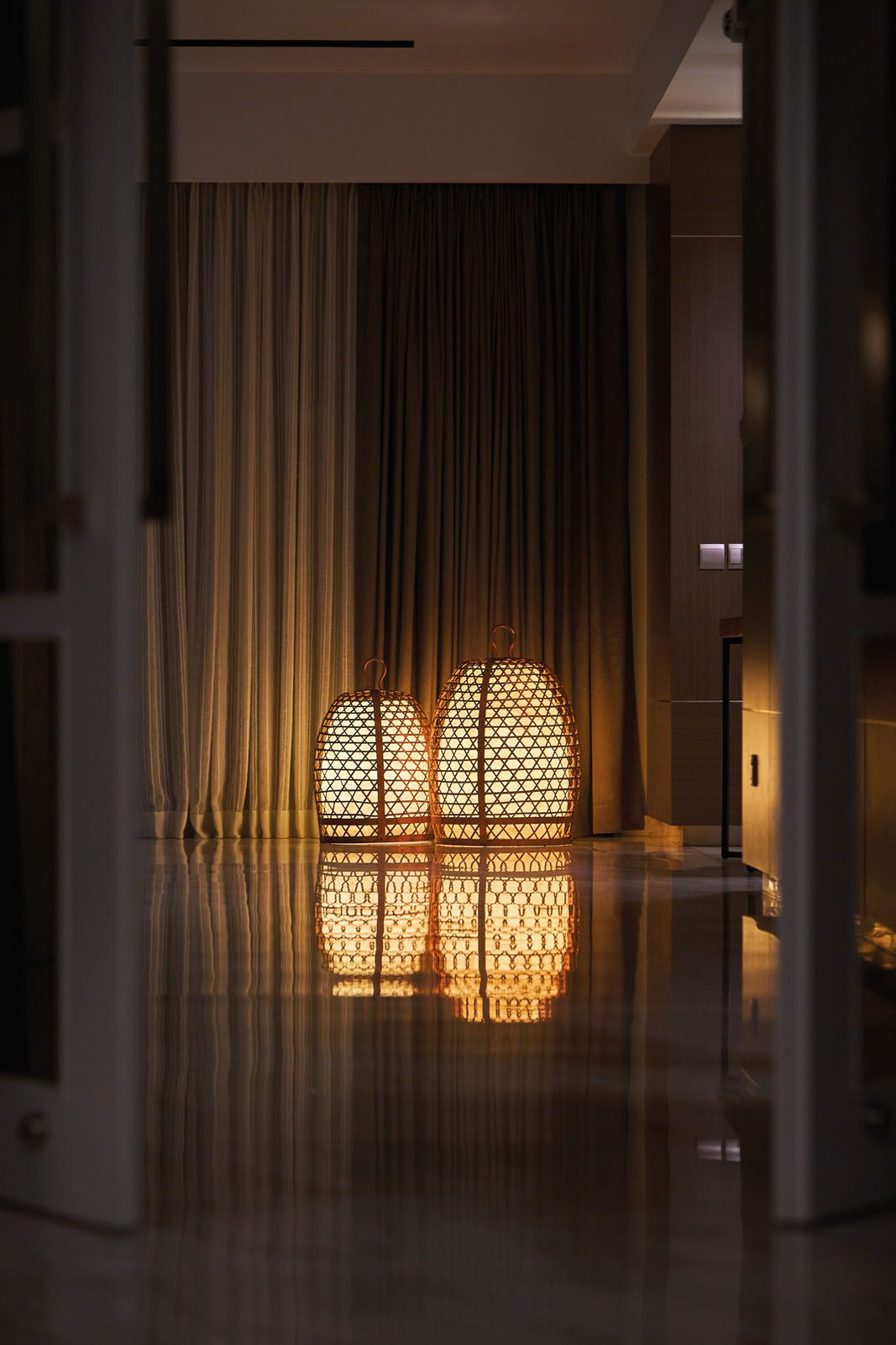 A pair of lantern-like lamps adds a warm glow to the corridor