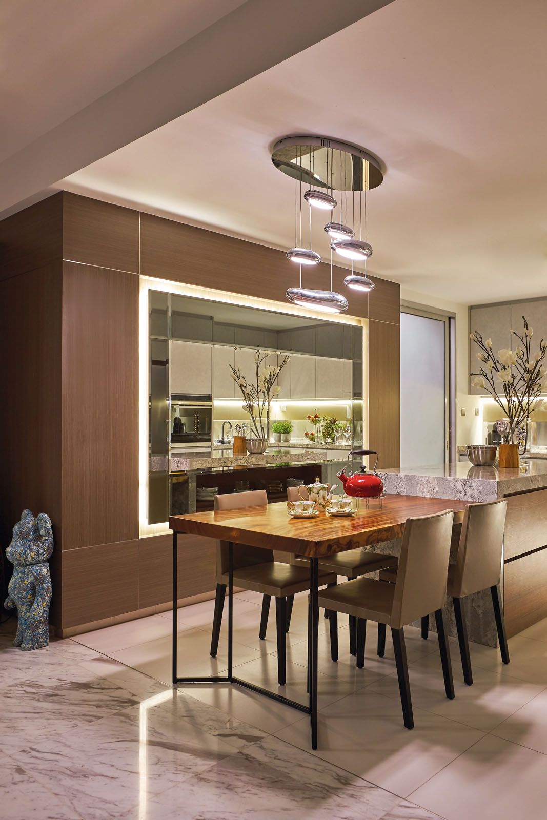 The mirrored feature wall creates an expansive sense of space in the kitchen