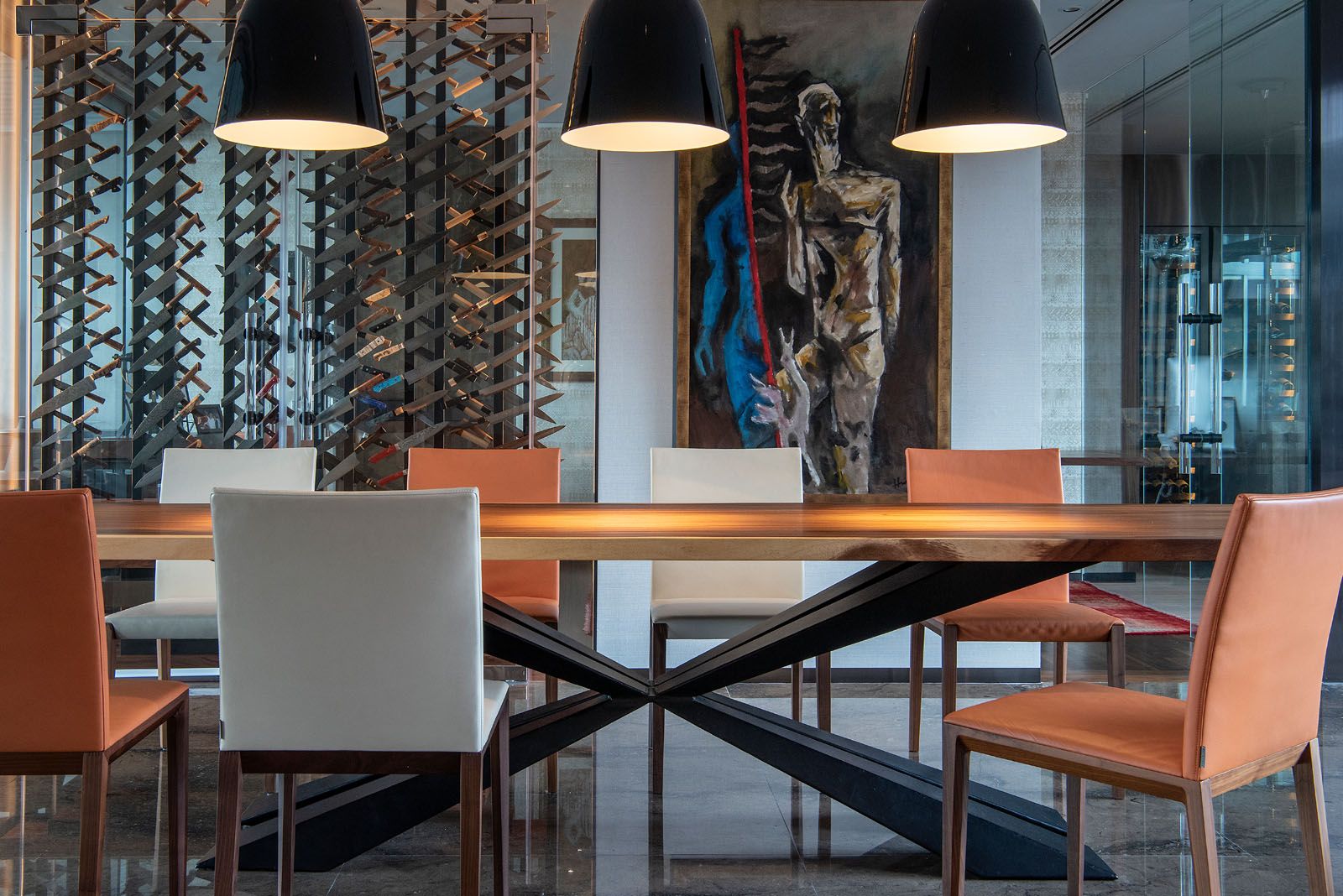 A bespoke glass cabinet that showcases the owner's collection of 300 custom-designed knives