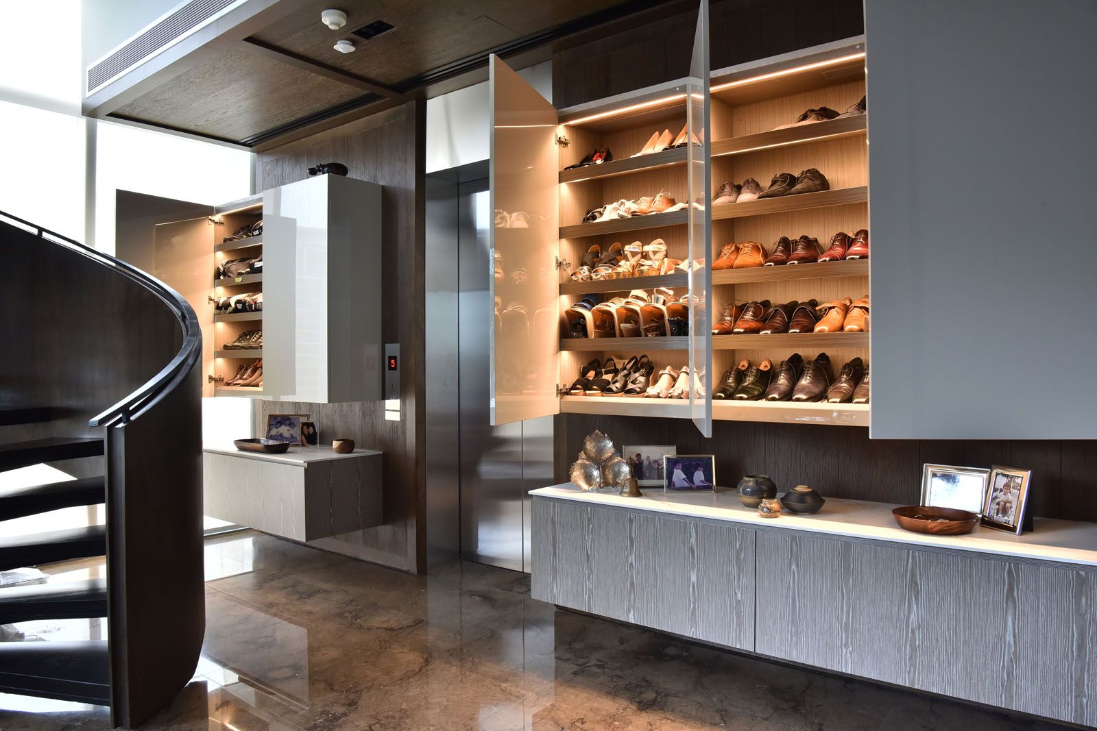Full-height cabinets at the lift lobby offers ample room for the couple's shoe collection