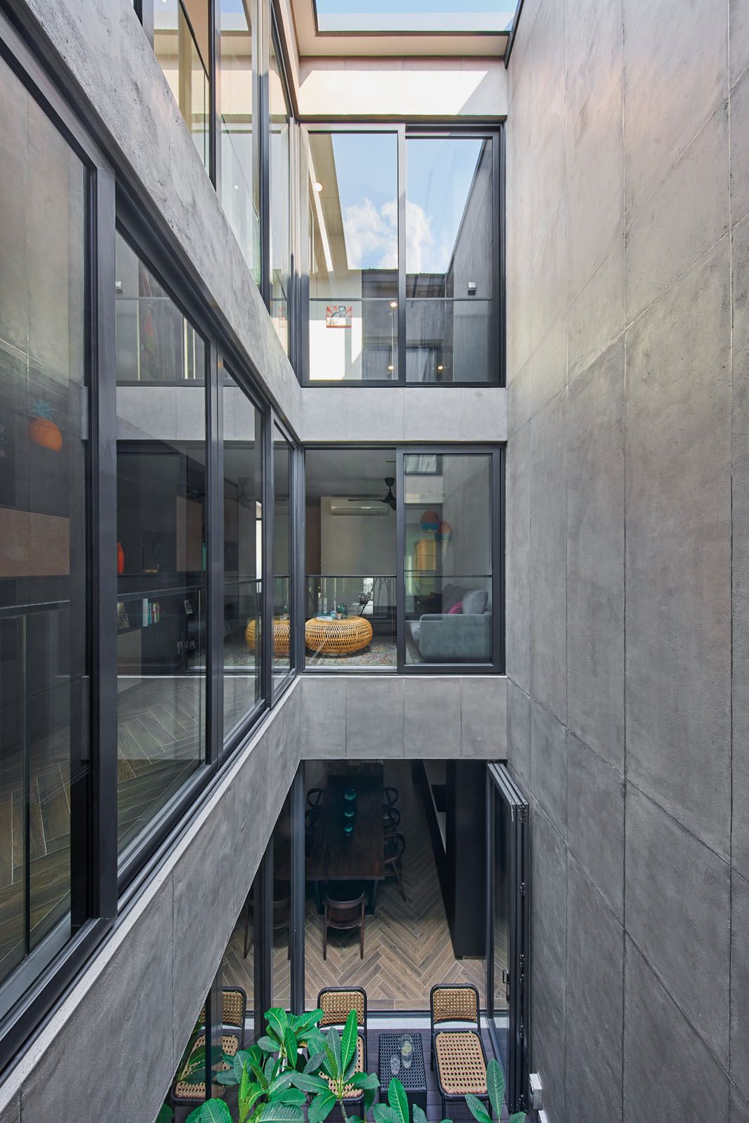 The three-storey house was planned around its central courtyard, which serves as its tropical nucleus
