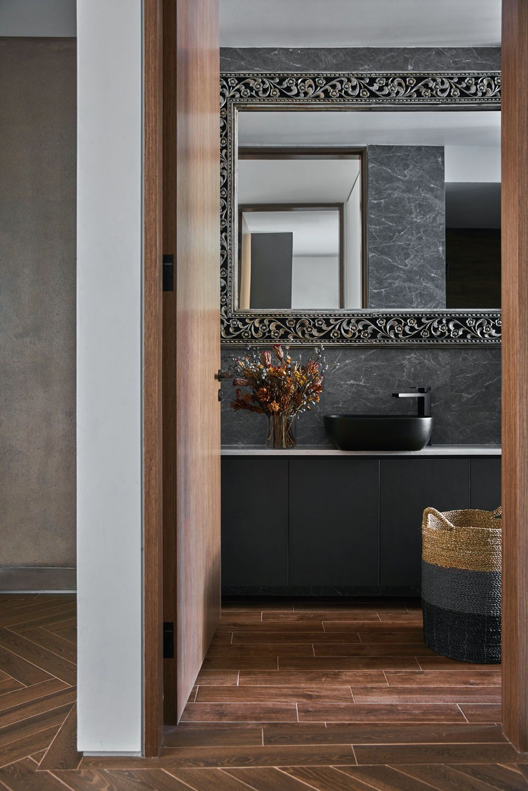 An ornate framed mirror is the centrepiece of this bathroom;