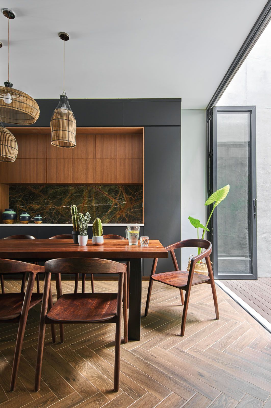 The dining area is furnished in a handsome mix of dark wood and marble