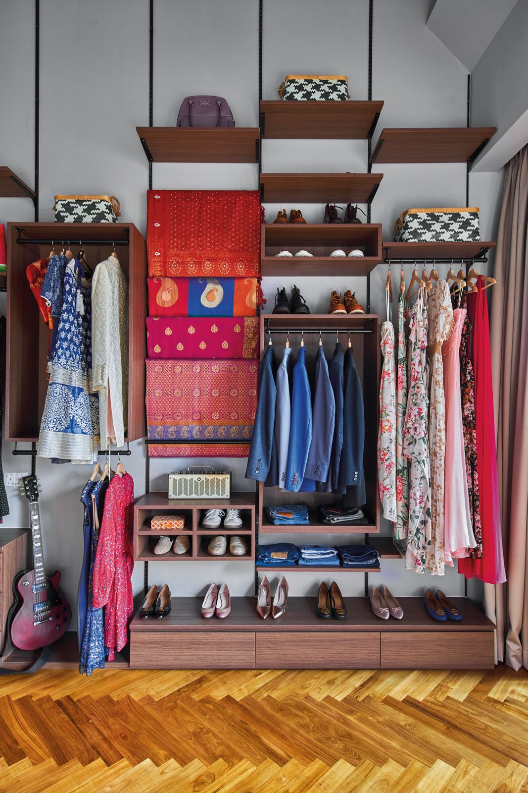 The open shelves in the master bedroom showcase the couple’s vibrant wardrobe and shoe collection