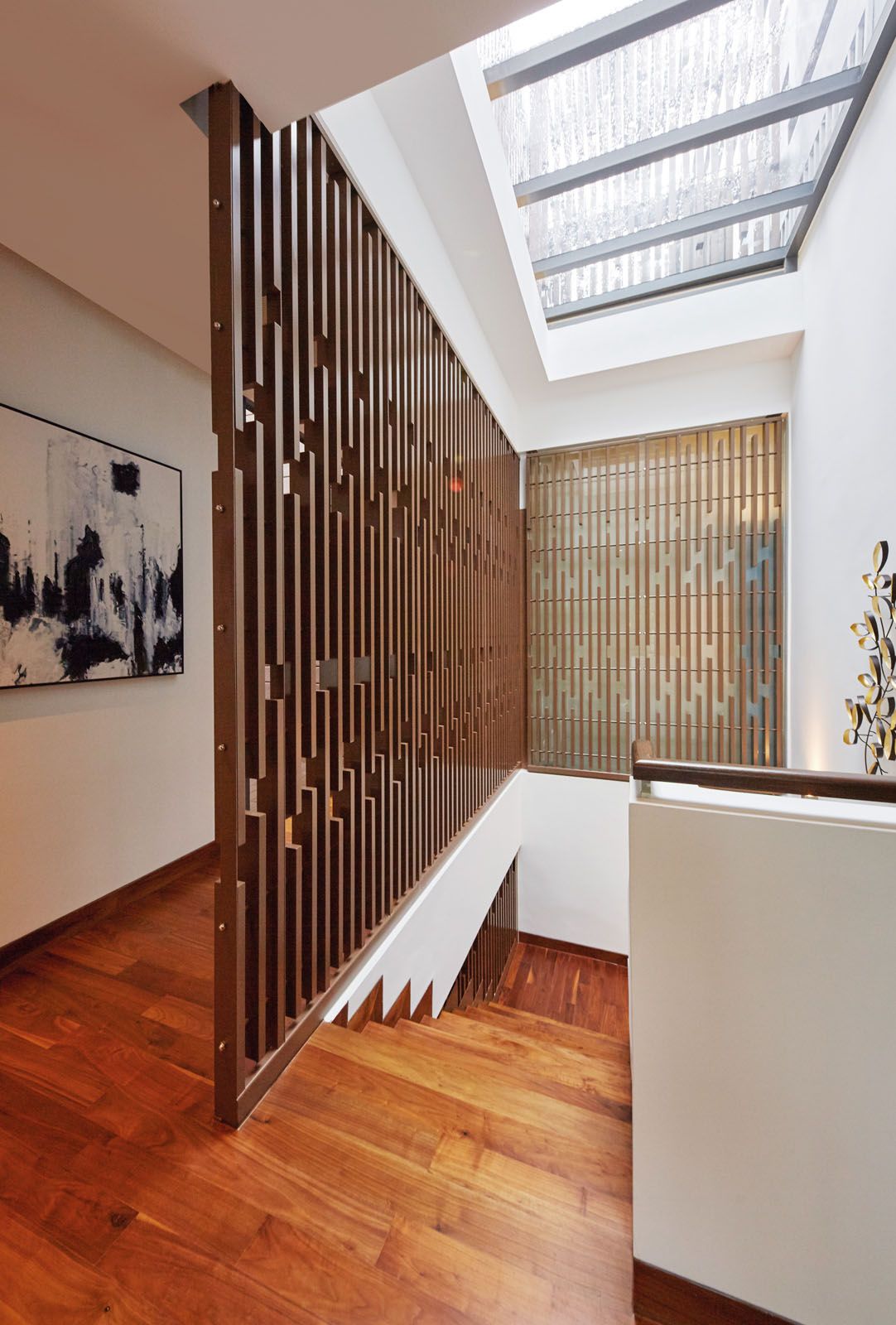 The wooden screens complement the angular proportions of the stairway