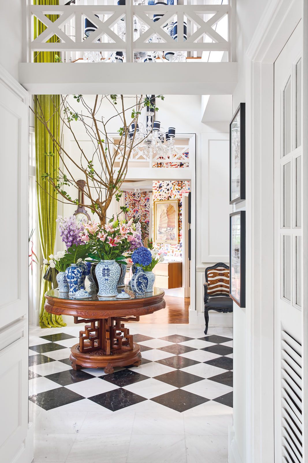 The vases in the entrance foyer offer a nod to the blue tones in the TV room and the rug in the billiard room