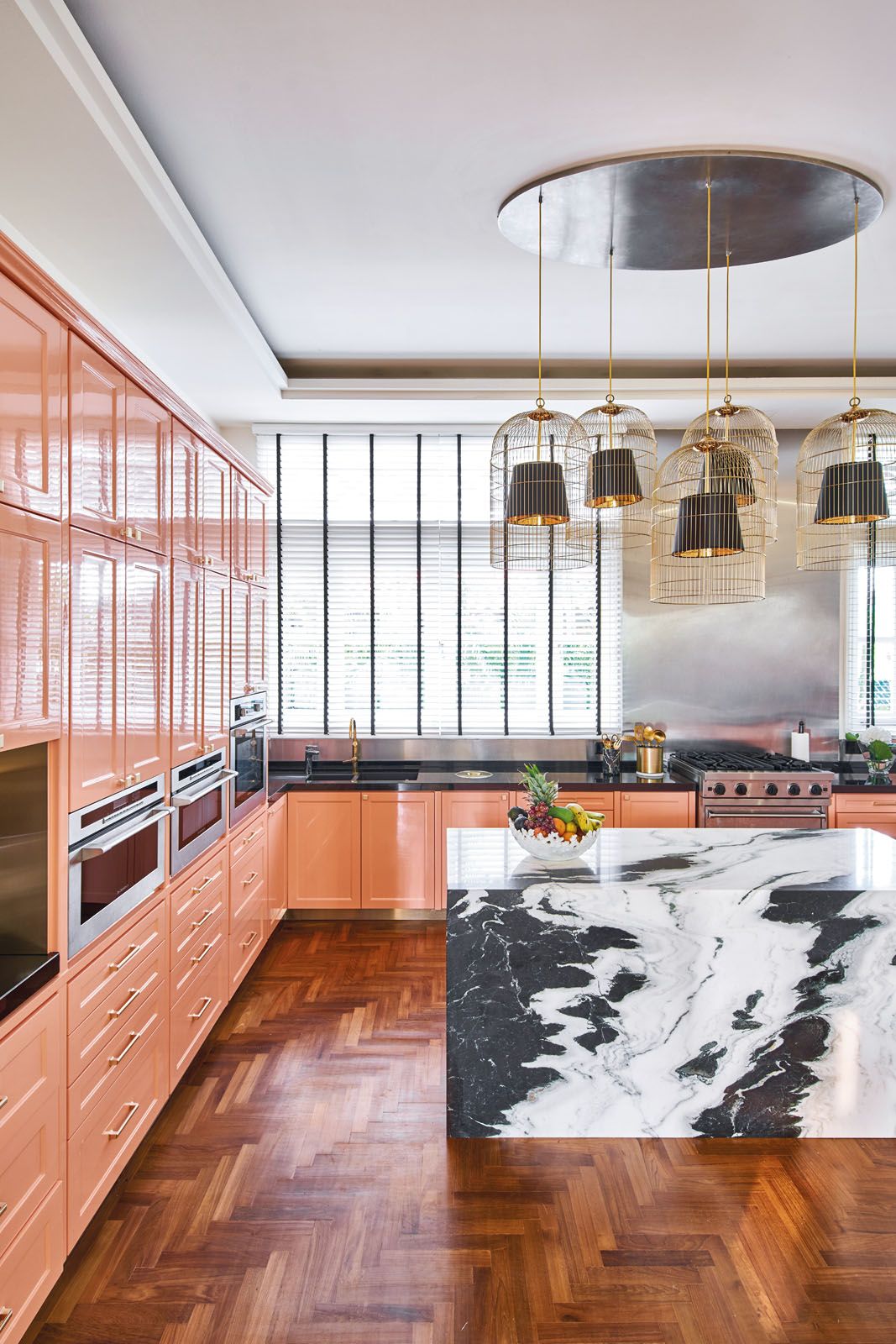 The cabinets in the dry kitchen have been painted in coral to tie in with the colour scheme of the TV room