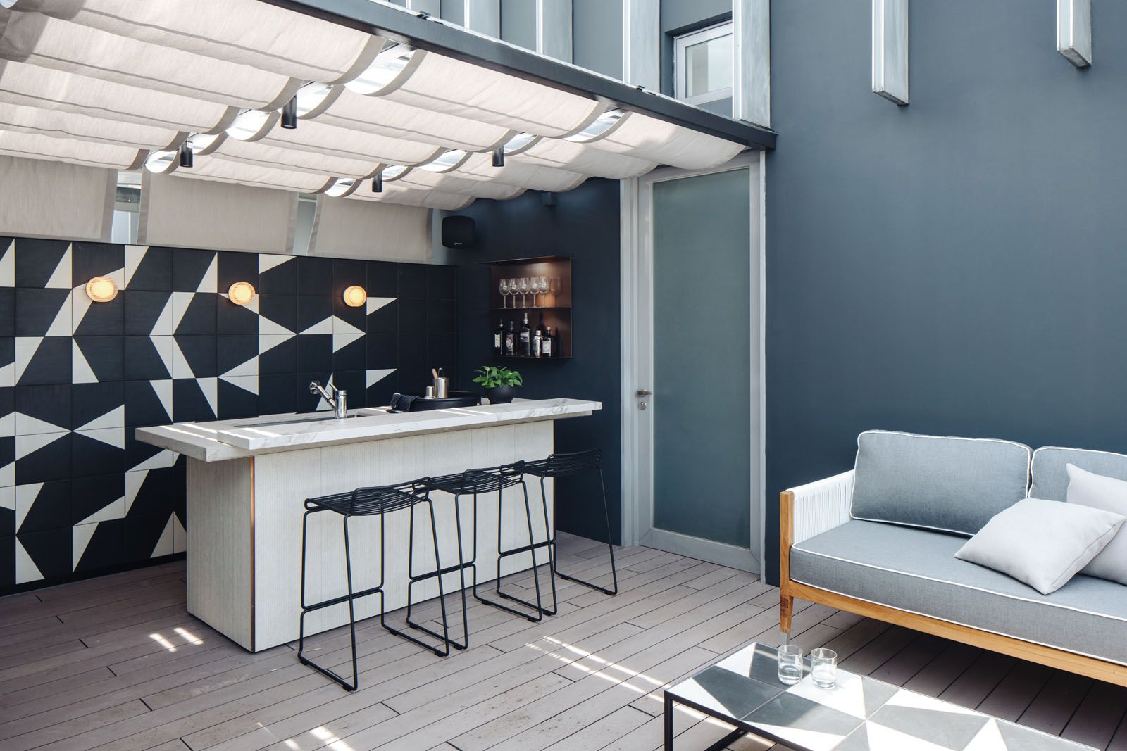 The feature wall and coffee table at the rooftop terrace are made from the same set of graphic tiles