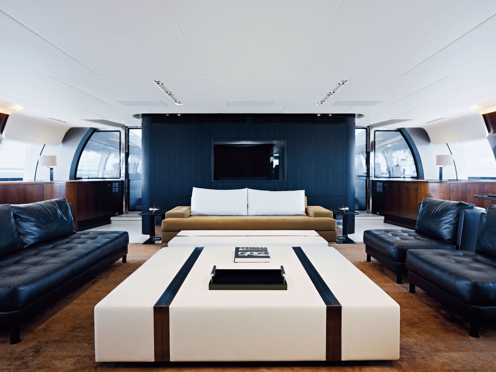 The main living room of the 67m yacht Vertigo features custom-made lounge chairs in black leather, which also inspired the creation of the Habano chair collection from Liaigre