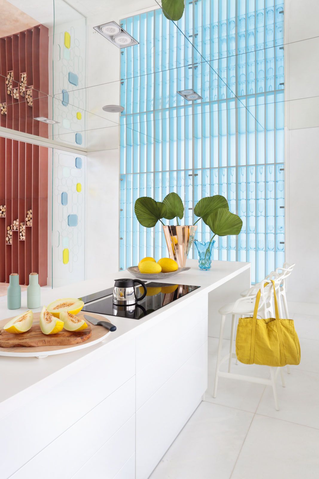 A custom-made glass cabinet in the kitchen showcases the family’s glassware