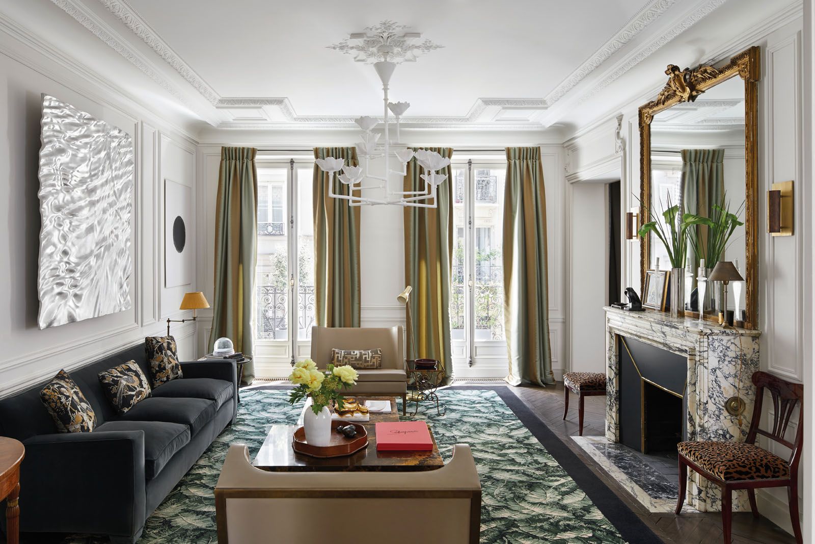 Contemporary accents in the living room include a plaster chandelier by Robert Lemariey and an artwork made with an aluminium alloy by Gregory Ryan