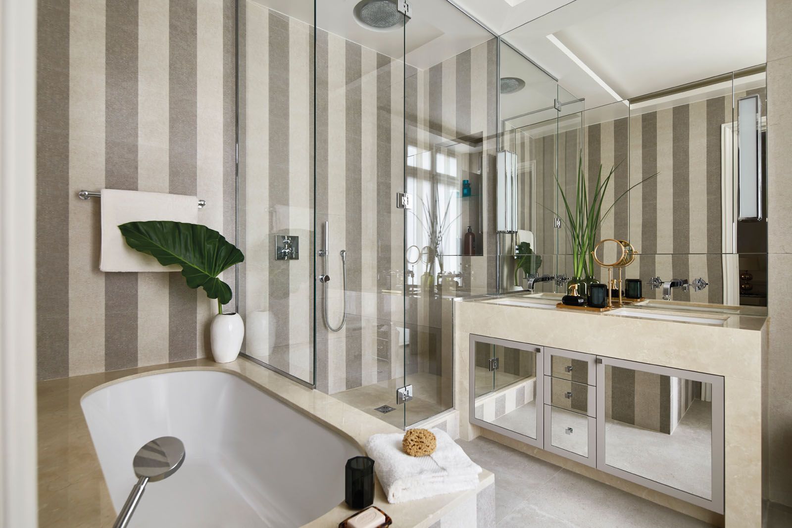The cabinetry and Kaldewei bathtub in the master bathroom both feature a Crema Marfil marble top