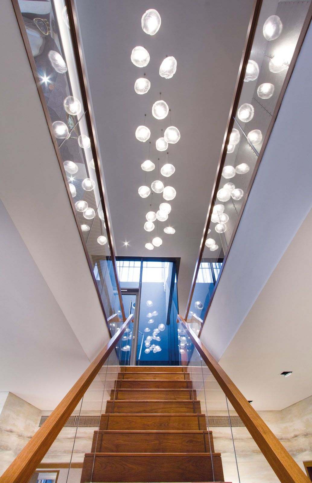 The Bocci pendant lights above the central staircase draw attention to the sense of space in the penthouse