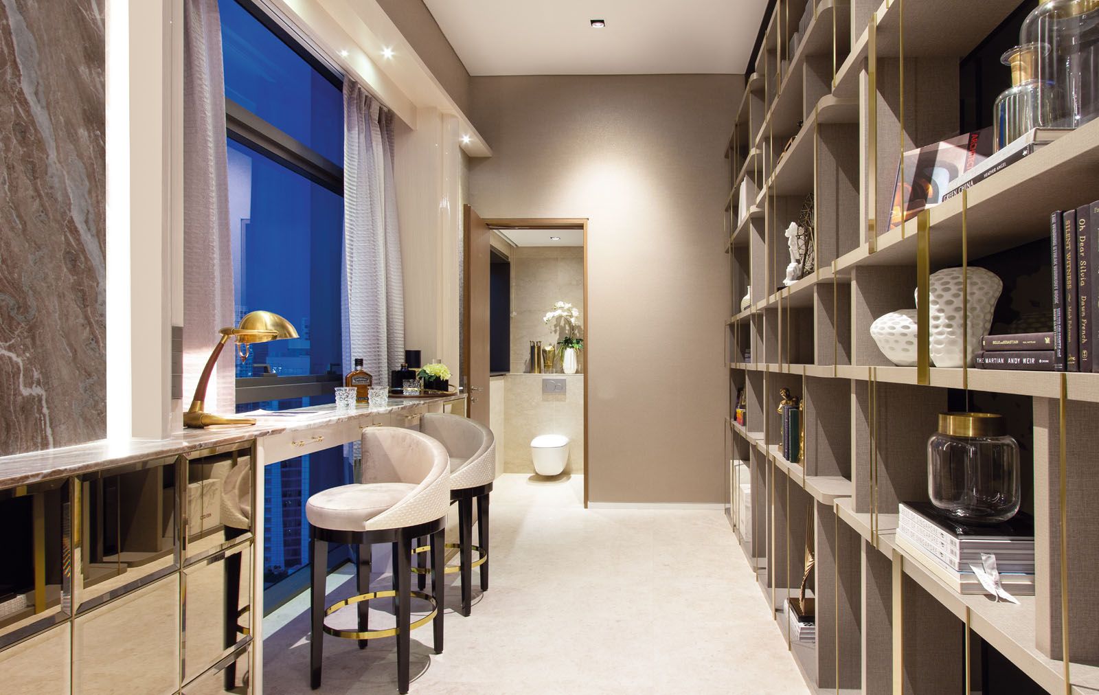 A bar area next to the living room is designed as both a pantry and library