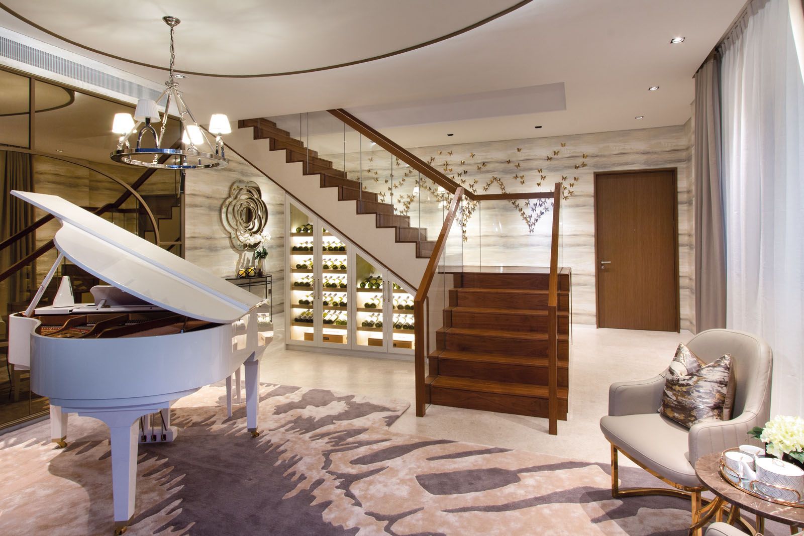 SuMisura installed illuminated shelves under the grand staircase to maximise the use of space in the lounge area