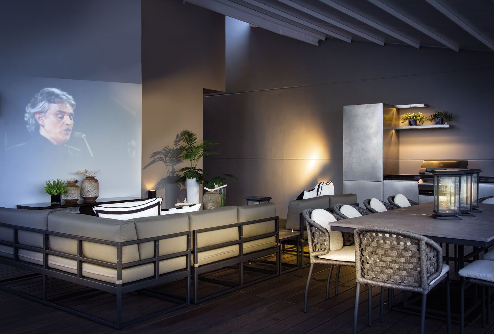 The outdoor terrace features a retractable roof and is furnished for film screenings and pool parties