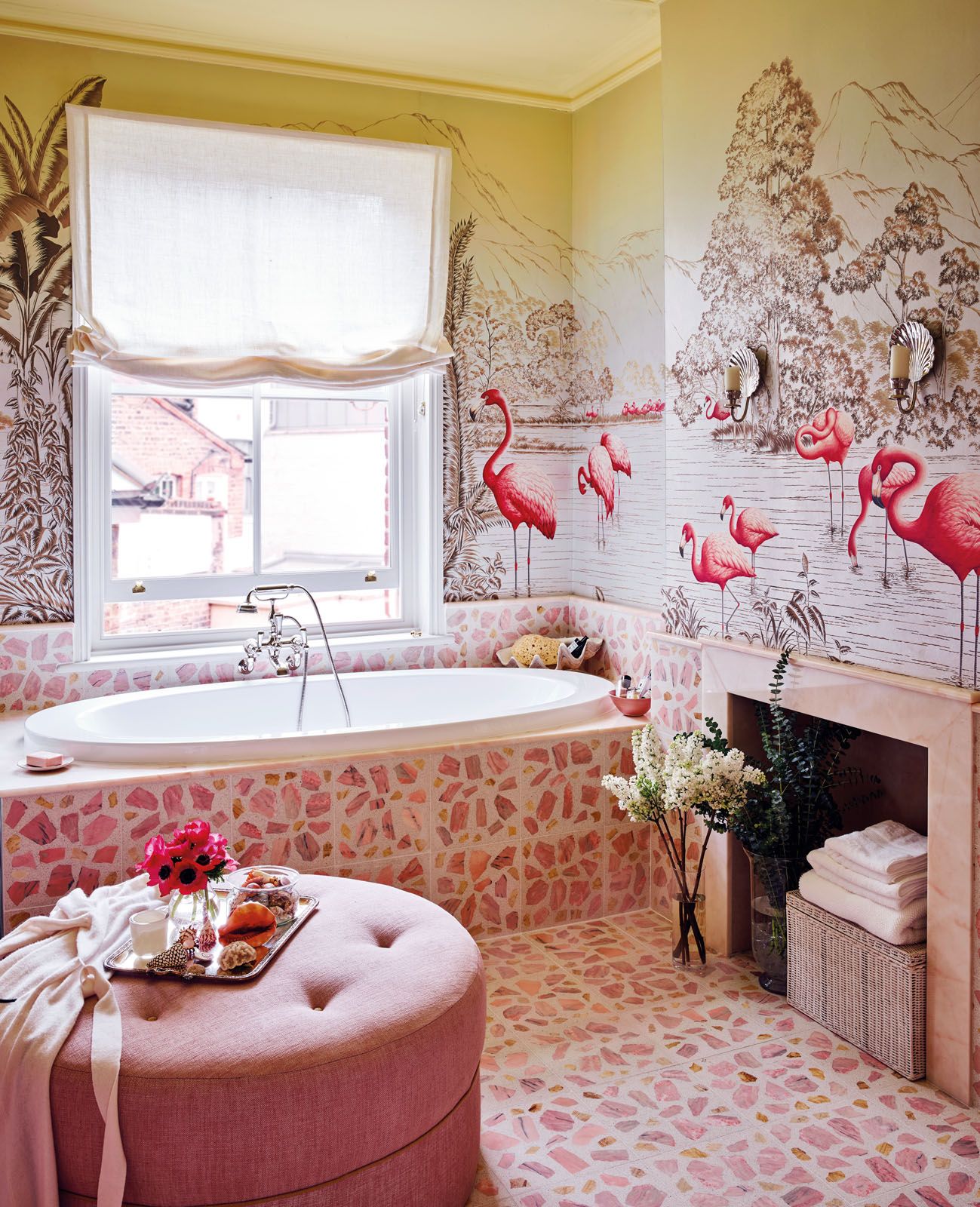 Pink terracotta tiles and the Flamingos wallpaper continue the pink scheme in the bathroom