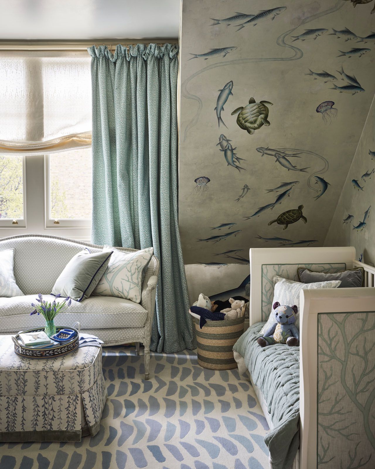 A custom wallpaper swimming with marine life brings a lively dimension to George’s blue bedroom