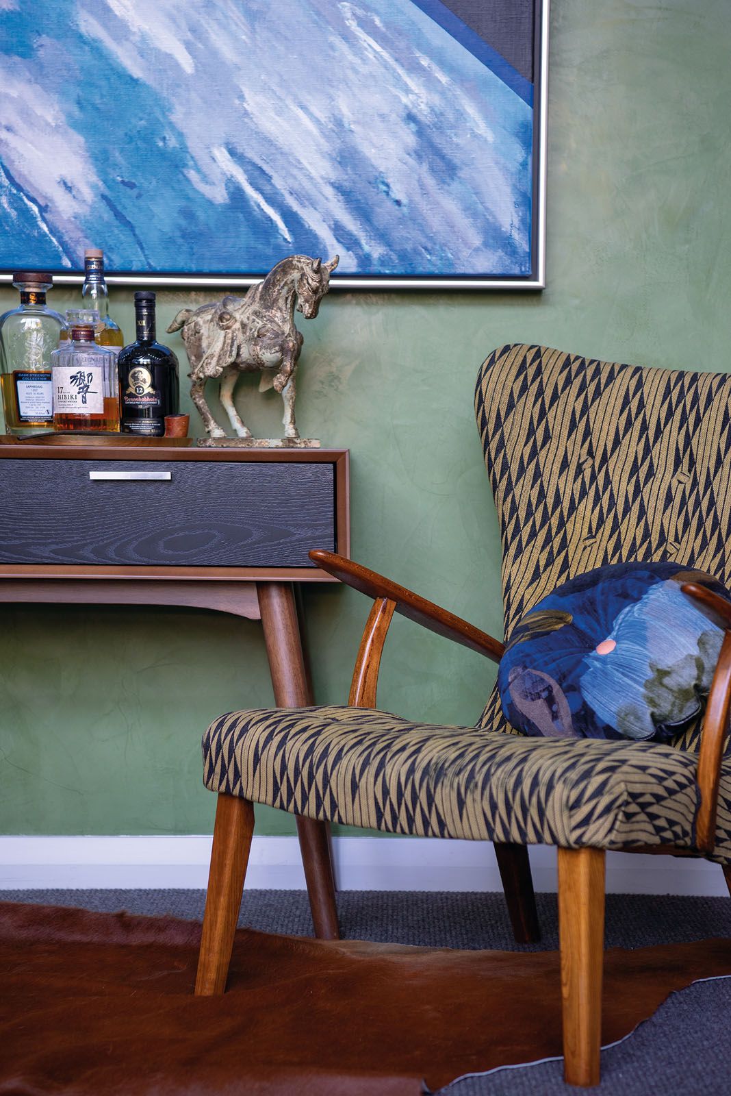 A retro-print armchair in the study references the Danish influence in the mid-century movement