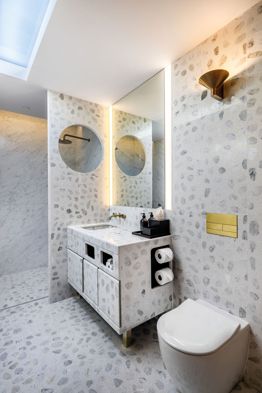 The terrazzo tile-clad bathrooms are serene, stylish cocoons